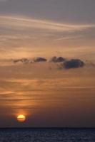 Sun setting over the sea, sunset in autumn on the beach of Zahara de los atunes, Cadiz, Andalucia, Spain photo