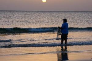 Sun setting over the sea, sunset in autumn on the beach of Zahara de los atunes, Cadiz, Andalucia, Spain photo