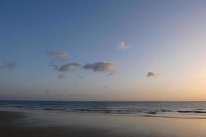 Sun setting over the sea, sunset in autumn on the beach of Zahara de los atunes, Cadiz, Andalucia, Spain photo