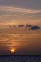 Sun setting over the sea, sunset in autumn on the beach of Zahara de los atunes, Cadiz, Andalucia, Spain photo