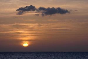 Sun setting over the sea, sunset in autumn on the beach of Zahara de los atunes, Cadiz, Andalucia, Spain photo