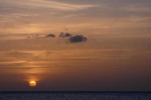 Sun setting over the sea, sunset in autumn on the beach of Zahara de los atunes, Cadiz, Andalucia, Spain photo