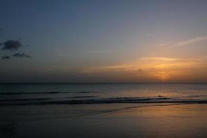 Sun setting over the sea, sunset in autumn on the beach of Zahara de los atunes, Cadiz, Andalucia, Spain photo