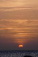 Sun setting over the sea, sunset in autumn on the beach of Zahara de los atunes, Cadiz, Andalucia, Spain photo