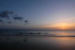 Sun setting over the sea, sunset in autumn on the beach of Zahara de los atunes, Cadiz, Andalucia, Spain photo