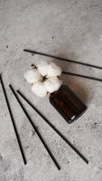 Transparent bottle of aroma diffuser. Parfum for home with cotton flowers photo