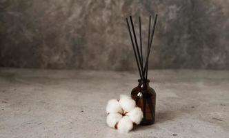 Aroma diffuser with cotton. Aromatherapy on a dark marble background photo