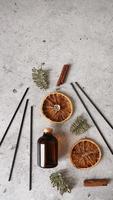 Citrus reed diffuser with cinnamon, dry orange and fir tree branches. photo