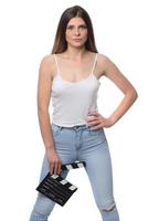 beautiful young woman with cinema clapper posing in studio. Movie concept. isolated photo