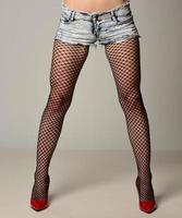 Beautiful, slim woman posing in fishnet stockings photo