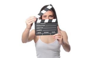 beautiful young woman with cinema clapper posing in studio. Movie concept. isolated photo