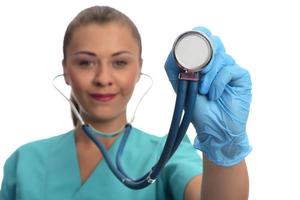 young female doctor holding stethoscope. isolated. photo