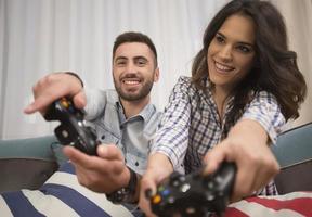 happy smiling couple playing video games at home. photo