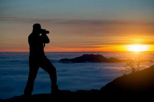 Sunset in the mountains in a sea of fog photo