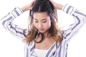 Young Asian woman playing with her hair photo