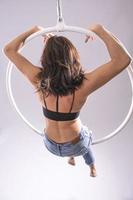 A female Aerial hoop gymnast  performing exercises on an Aerial hoop photo