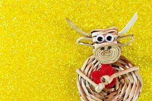 Ox with red heart on yellow background with sparkles. Christmas and New Year background. Symbol of year. Valentine's Day. Copy space photo