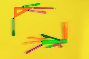Back to school. Frame made of stationery. Rulers, markers, markers, pens, compasses. Place for text. Learning concept. Copy space photo