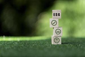 ESG concept of environmental, social and governance. words ESG on a wood cube is an idea for sustainable business organizational development. photo