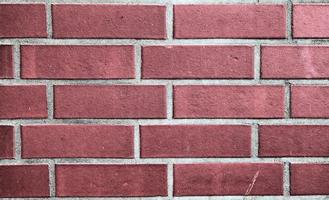 Detailed view at a colorful old and weathered brick wall texture as a panoramic background. photo