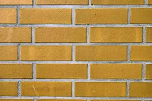 Detailed view at a colorful old and weathered brick wall texture as a panoramic background. photo