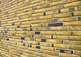Detailed view at a colorful old and weathered brick wall texture as a panoramic background. photo