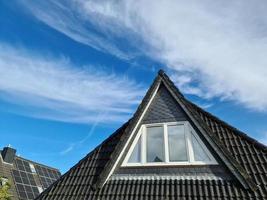 Open roof window in velux style with black roof tiles. photo