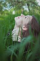 Close up woman in tall grass looking up at sky portrait picture photo