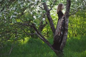 Standing on tree branch woman covered with shawl scenic photography photo