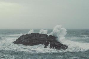 Old rock in stormy sea waves landscape photo