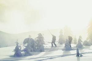 Travelers moving over snow on skis landscape photo