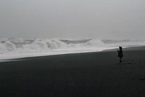 Stormy sea beach with person monochrome landscape photo