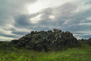 Old rock in green field landscape photo