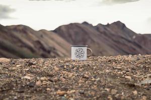 Close up enamel mug on pebble concept photo