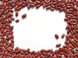 Scattered red beans as frame with white space inside the frame photo