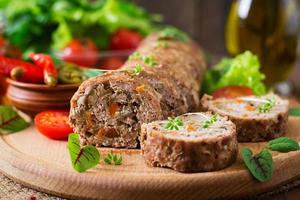 Minced meat loaf roll with mushrooms and carrots photo