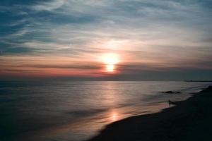 dramática puesta de sol en la playa de coney island foto