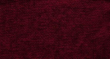 Texture of smooth knitted sweater with pattern. Handmade knitting wool or cotton fabric texture. Background of Large knit pattern with knitting needle or crochet. Color Of The Year 2023 - Viva Magenta photo