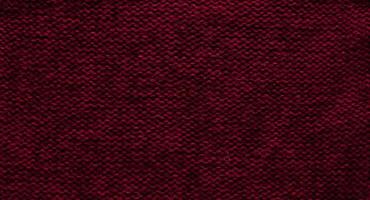 Texture of smooth knitted sweater with pattern. Handmade knitting wool or cotton fabric texture. Background of Large knit pattern with knitting needle or crochet. Color Of The Year 2023 - Viva Magenta photo