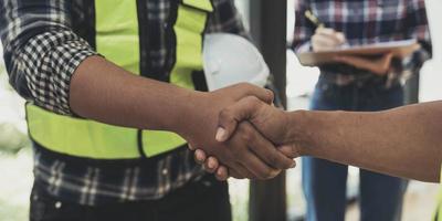 construction worker team hands shaking after consultation meeting to greeting start up plan new project contract in office photo