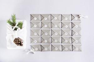 Envelopes for the advent calendar and furoshik with fir branches on a gray background photo