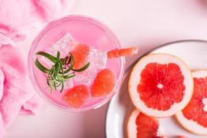 Pink cocktail with rosemary in glasses on the table. Pink food concept. Top view. Closeup photo