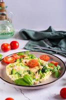 Omelet with broccoli and shrimp on a plate on the table. Homemade Protein Meal. Vertical view photo