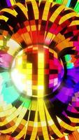 Disco ball on a bright multi-colored background. Vertical looped video