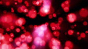 Beautiful festive bokeh effect, red love circles of light shining falling falling glowing christmas new year on black background. Abstract background. Screensaver, video in high quality 4k