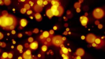 Beautiful festive bokeh effect, orange gold circles of light shining falling falling glowing christmas new year on black background. Abstract background. Screensaver, video in high quality 4k