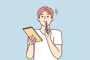 Positive thoughtful man with notebook in hand puts pen to face while thinking about difficult task. Boy high school student preparing for exams or important olympics. Flat vector illustration