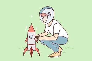 Little boy squatting near toy rocket representing launching spaceship to another planet. Child plays as astronaut, wanting to work in space industry and launch intergalactic ships. Flat vector design