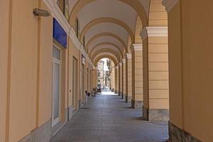 Picture along an old archway with pastel-coloured stone columns photo