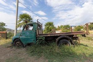 Picture of a weathered and unusable transporter in a field in daylight photo